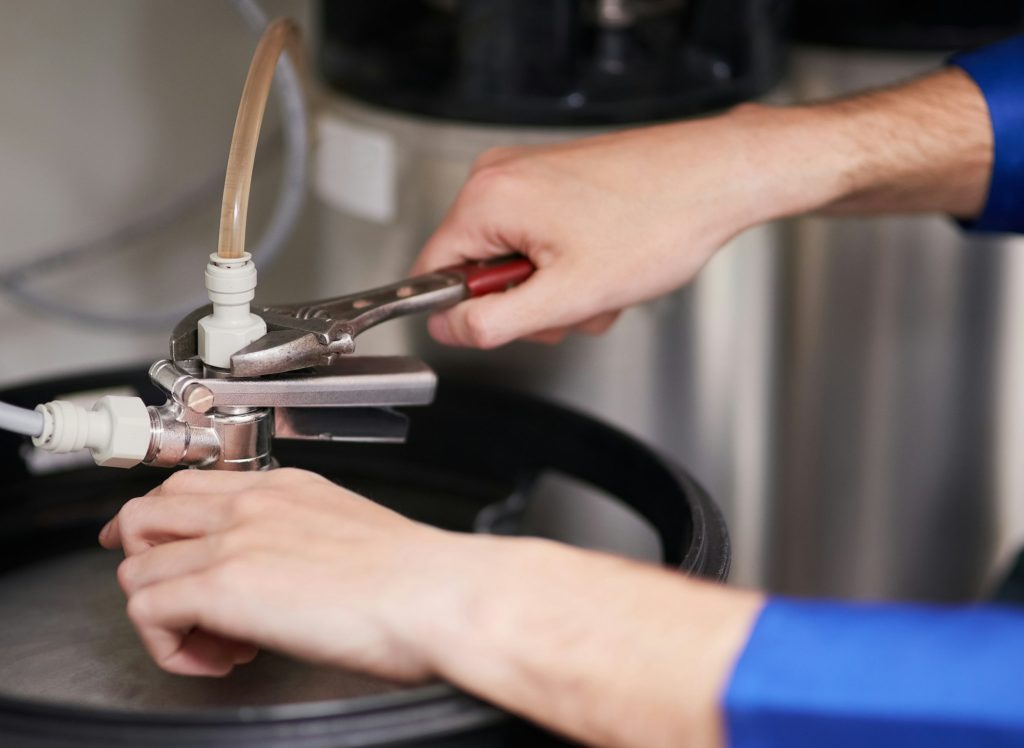 Cropped shot of a handyman repairing a pipe on a water heater