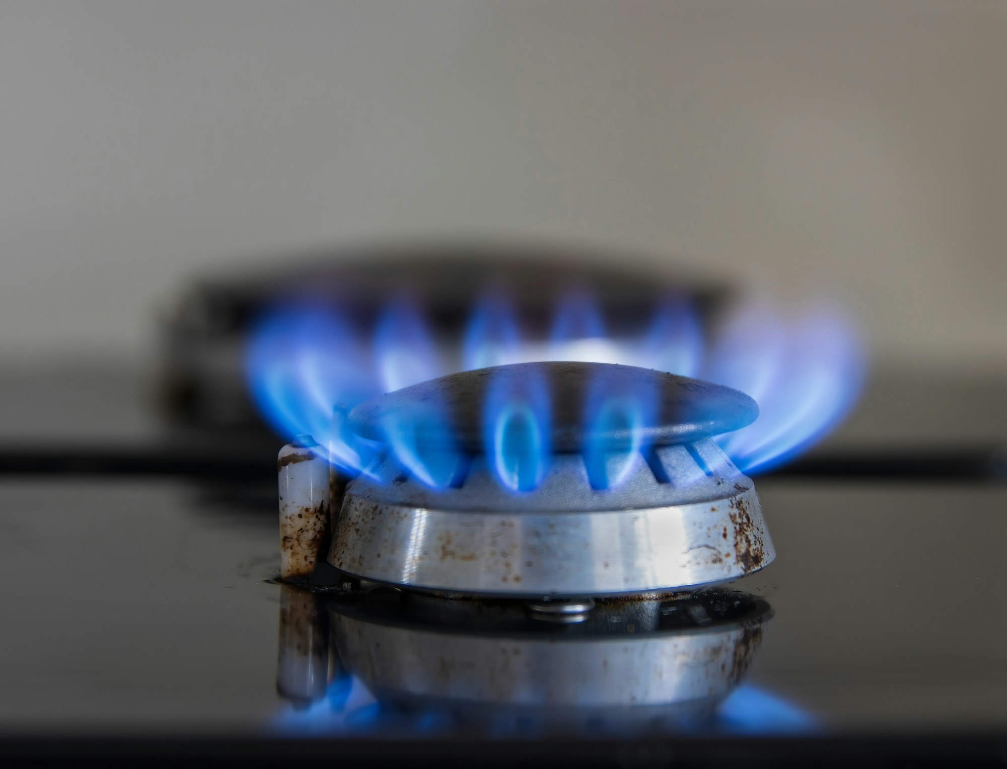 Hob burning natural gas, black enamel with blue flame concept