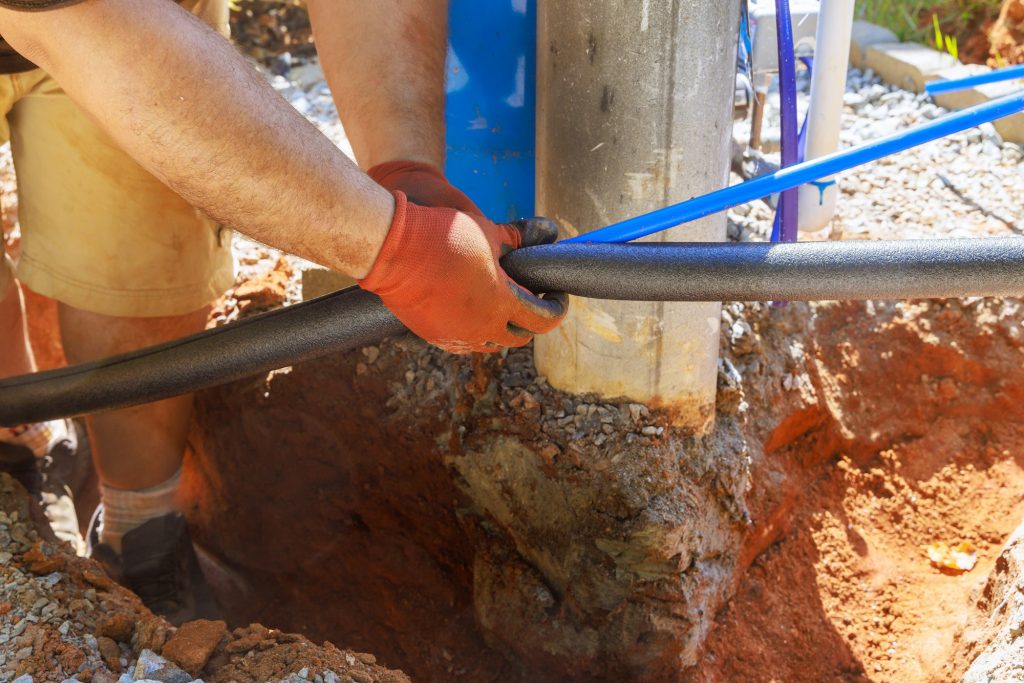 Plumber applied thermal insulation isolation to water pvc a pipe before installing it