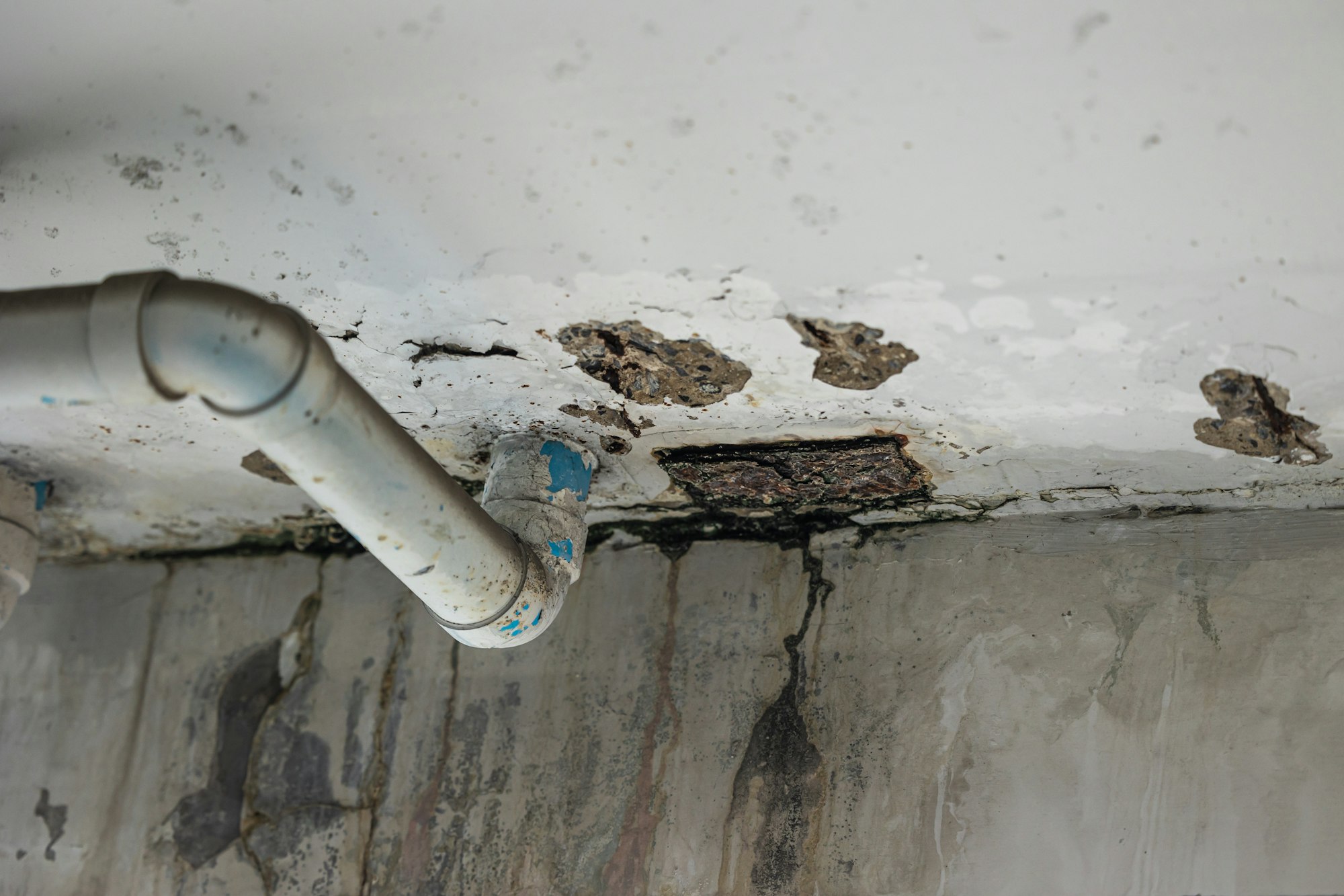 Sewer pipe leak bad old plumbing water leakage inside the concrete wall rusty damaged building